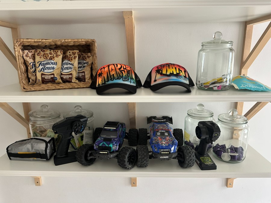 On the shelf, next to the Thunder monster truck