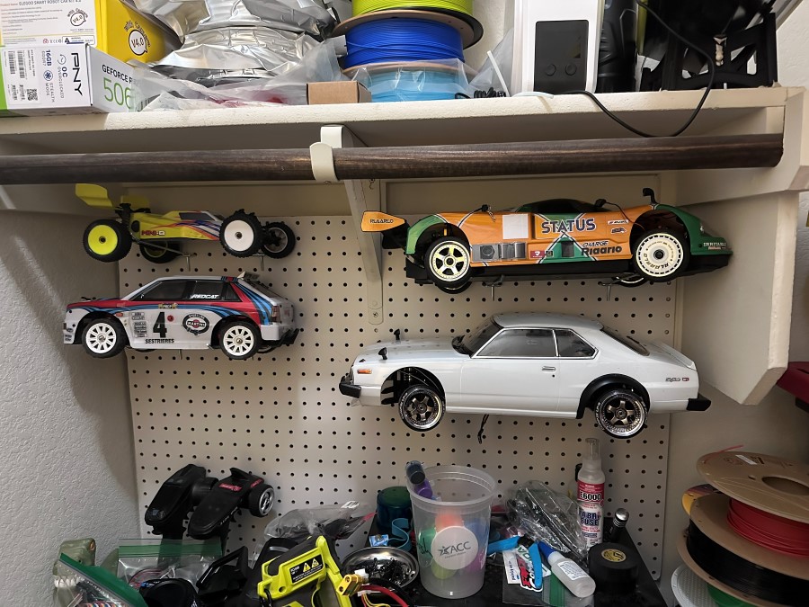 On the pegboard, with the rest of the display shelf